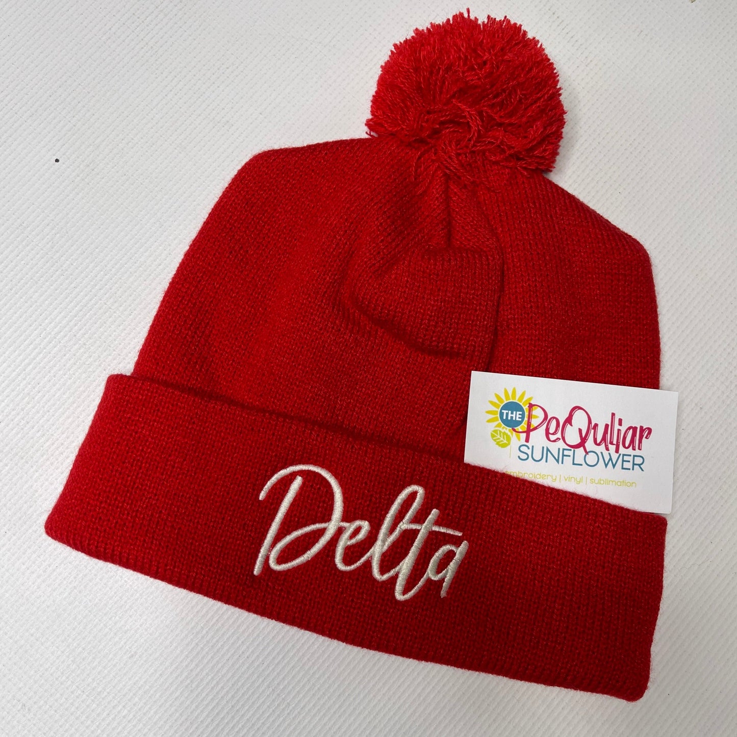 Delta pom beanie